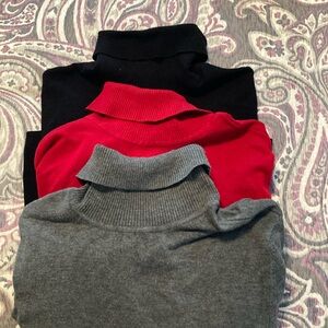 Three Chico’s turtleneck sweaters in black, red and grey